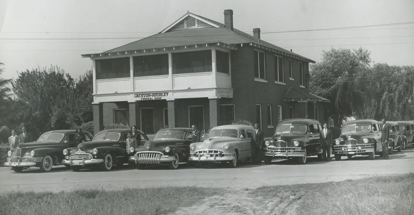 Historic Jackson and Highley Funeral Home with vintage cars parked in front